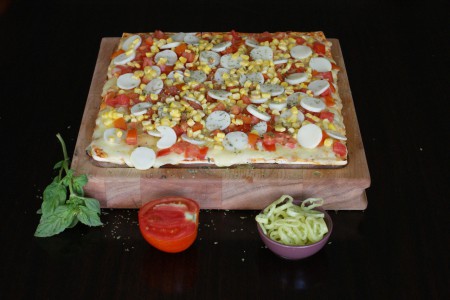 Pizza Palmito: Doble queso, Tomate, Choclo, Palmito y Oregano.